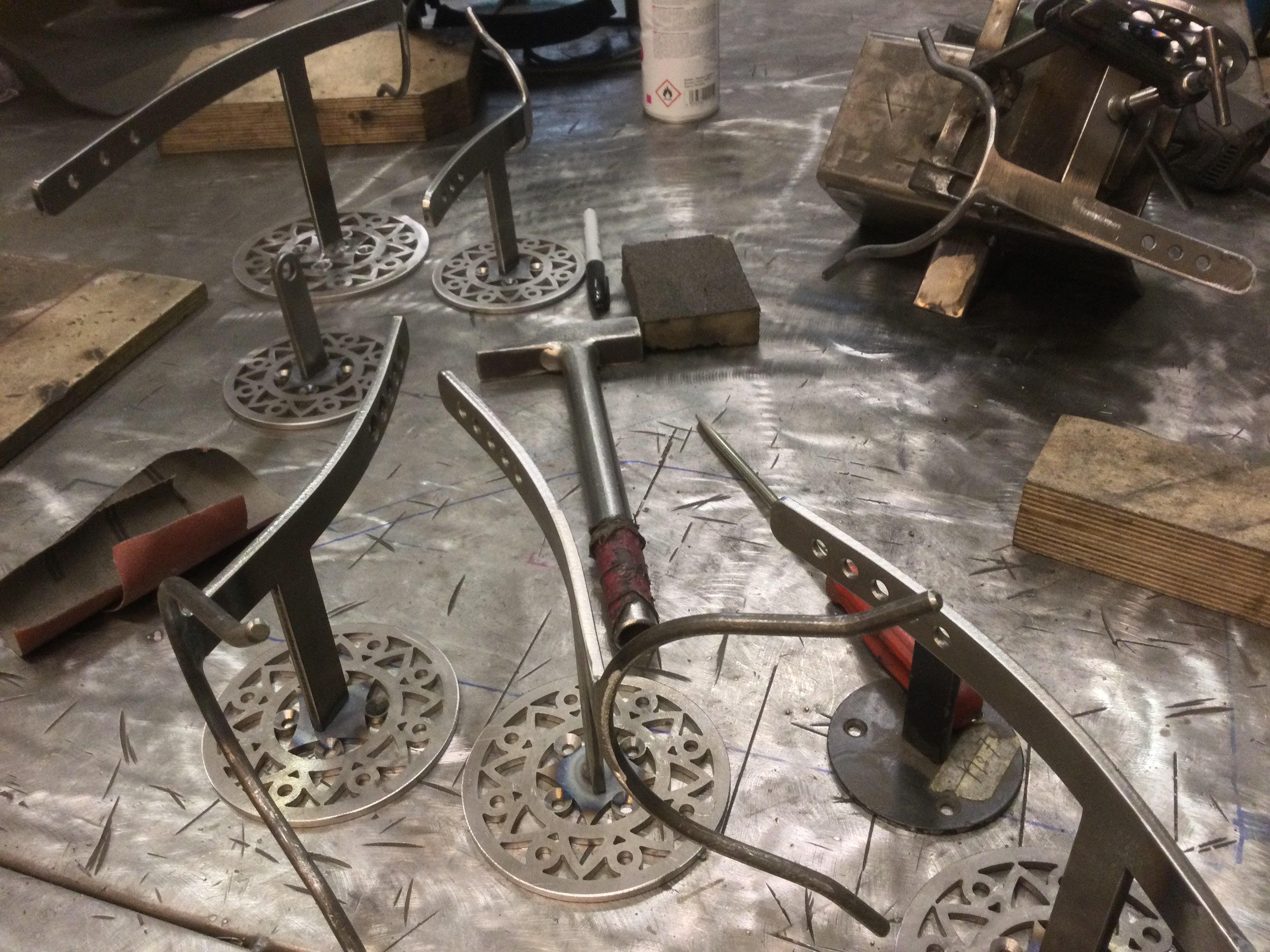 unfinished steel  Aztec saxstands on workbench just after welding stem to wall plate