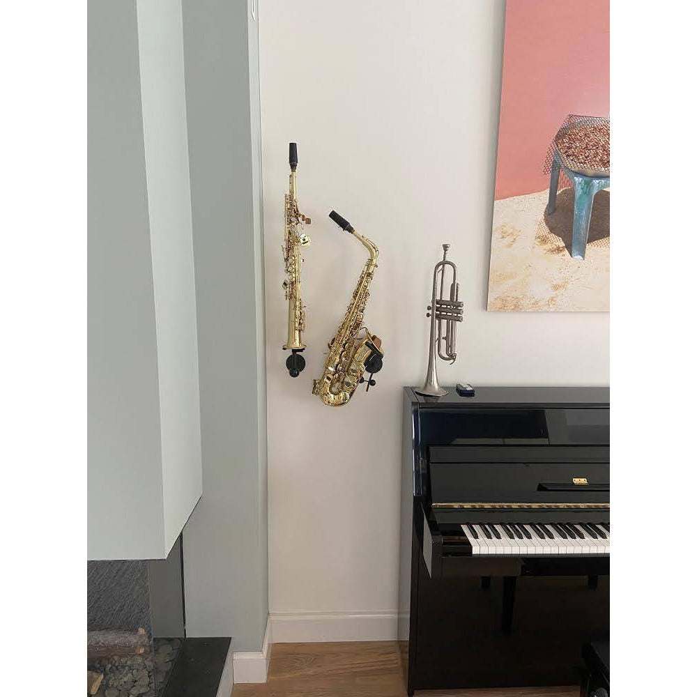 customer's stylish interior with saxophones mounted on the wall between fireplace piano with trumpet and art