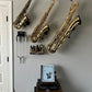 hallway with several saxophones mounted in wall stands