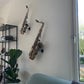 modern livingroom with alto and tenor saxophone in wallmounts by Locoparasaxo