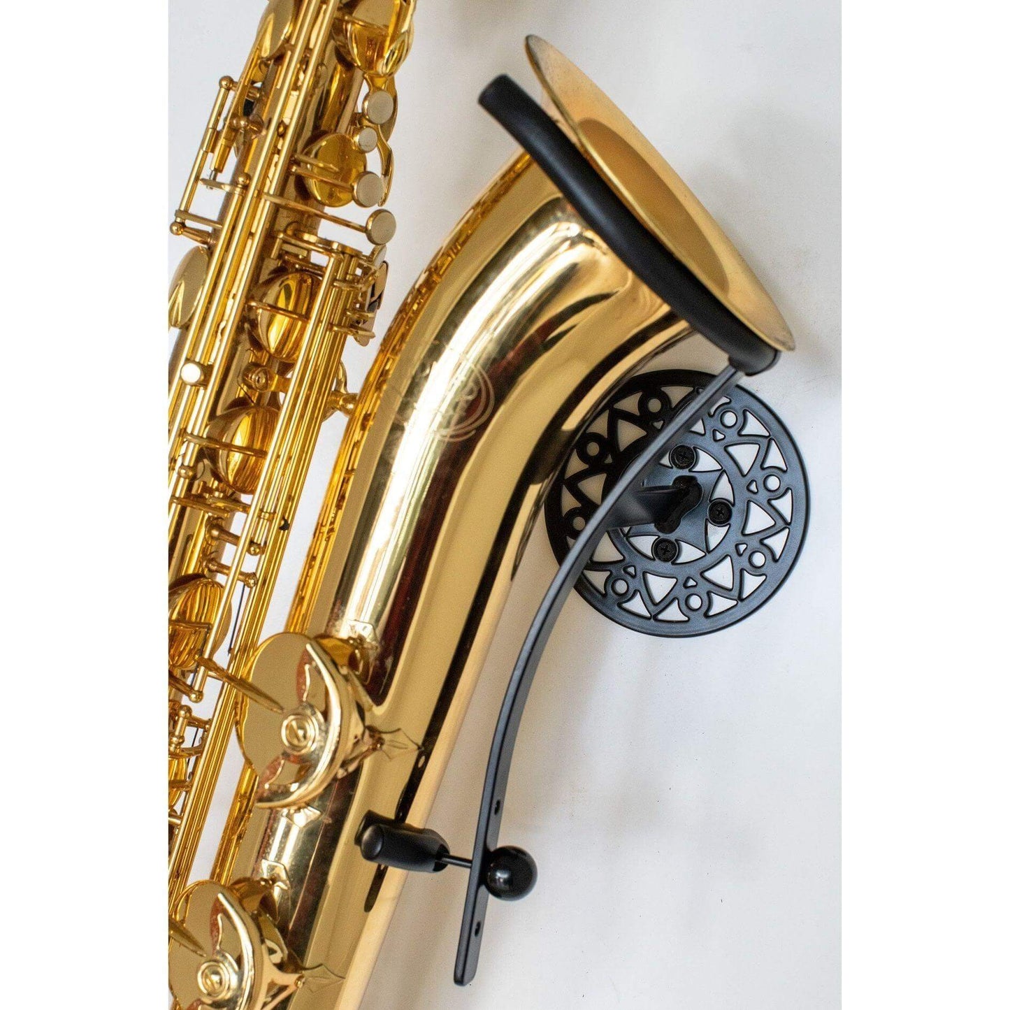 golden Jupiter baritone saxophone in wallmount Aztec on white wall by Locoparasaxo.com