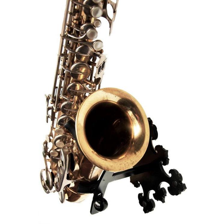 angled view alto saxophone in stand with decorative wall plate Prince on white backdrop Locoparasaxo product pic