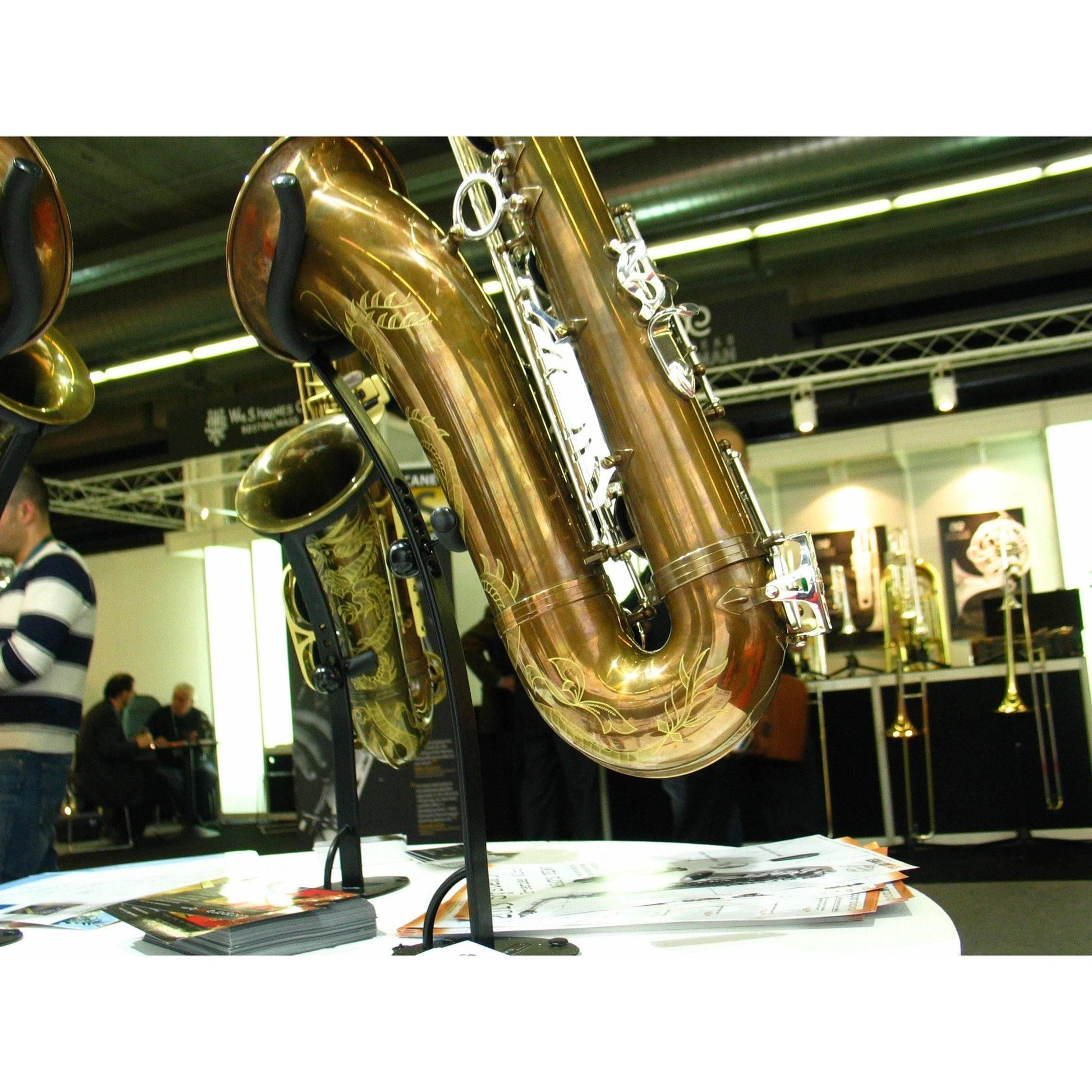 close up exhibit desktop tenor saxophone stands with instruments on display in the foreground by Locoparasaxo