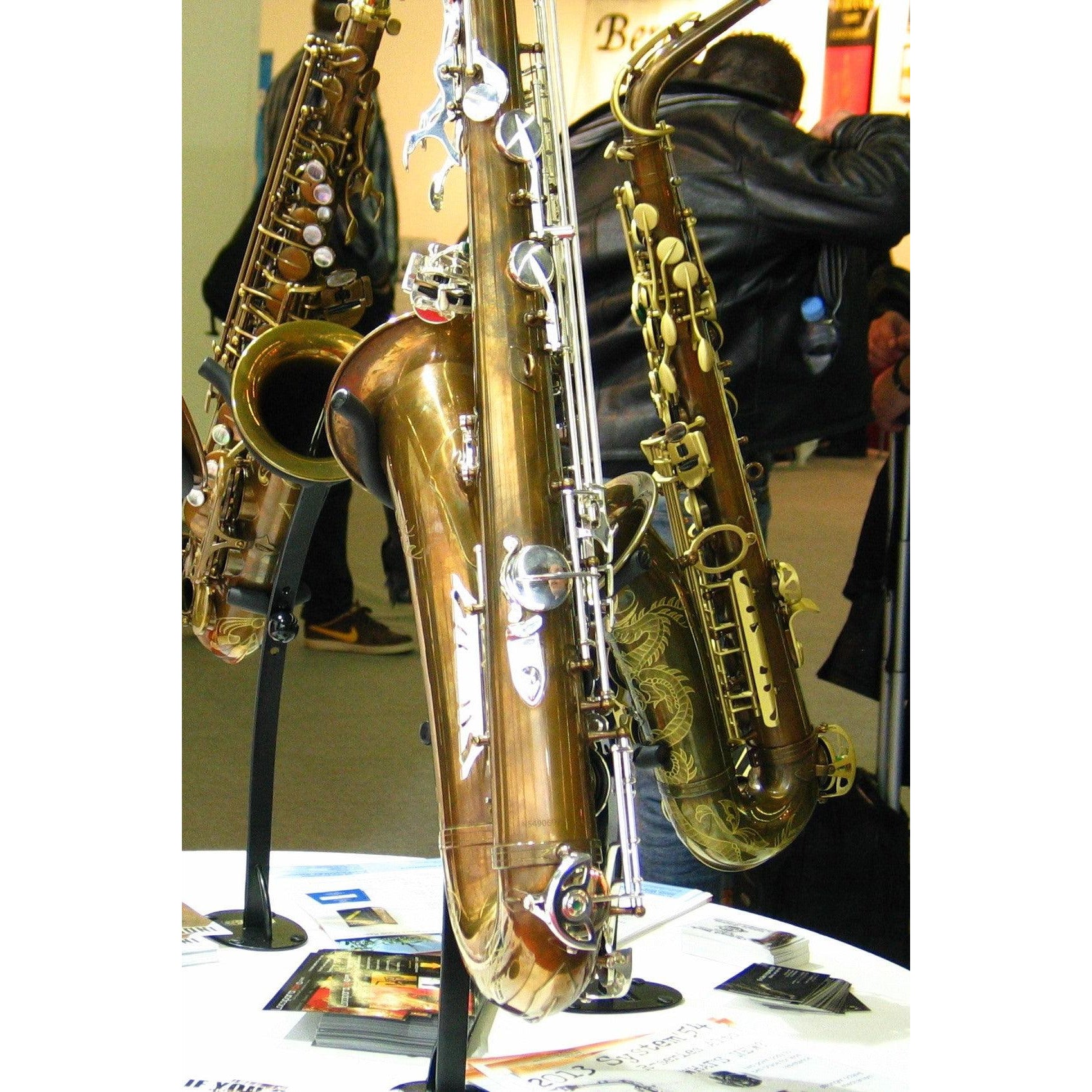 several saxophones at tradeshow in exhibit desktop tenor saxophone stands with instruments on display in the wallmounts made by Locoparasaxo