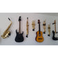 guitars saxophones and trumpets mixed mounted on Locoparasaxo customer home wall