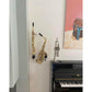 customer's stylish interior with saxophones mounted on the wall between fireplace piano with trumpet and art