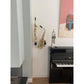 customer's stylish interior with saxophones mounted on the wall between fireplace piano with trumpet and art 
